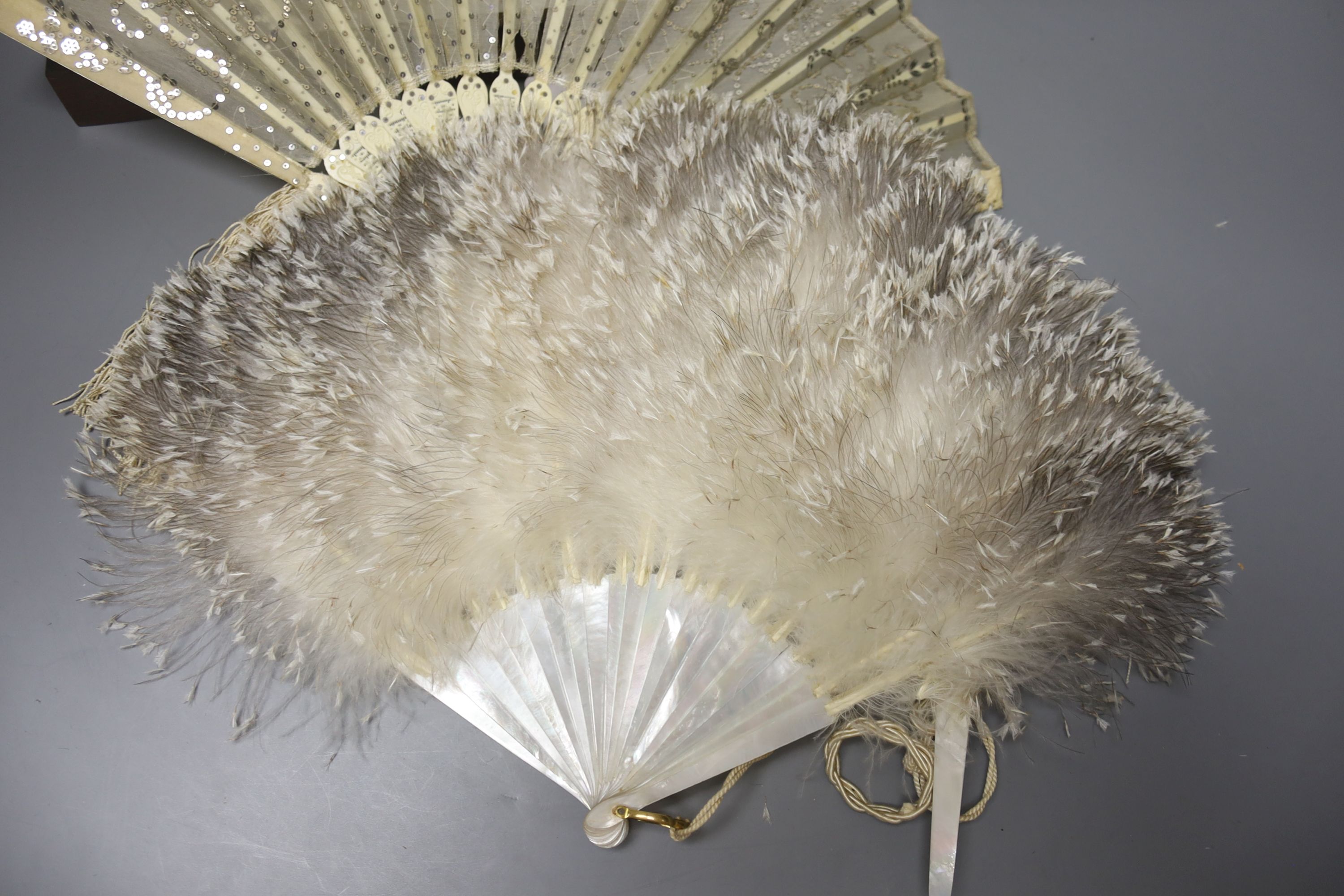 An ivory page turner with embossed white metal handle, a pair of opera glasses and three fans, various